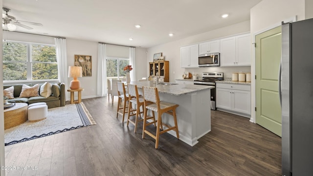 kitchen with white cabinets, recessed lighting, stainless steel appliances, dark wood-type flooring, and ceiling fan
