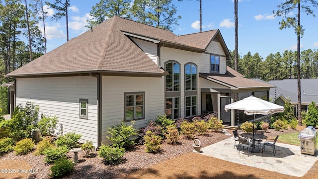100 Holly Springs Ct, Southern Pines, NC 28387 - back of property with a patio area and a shingled roof