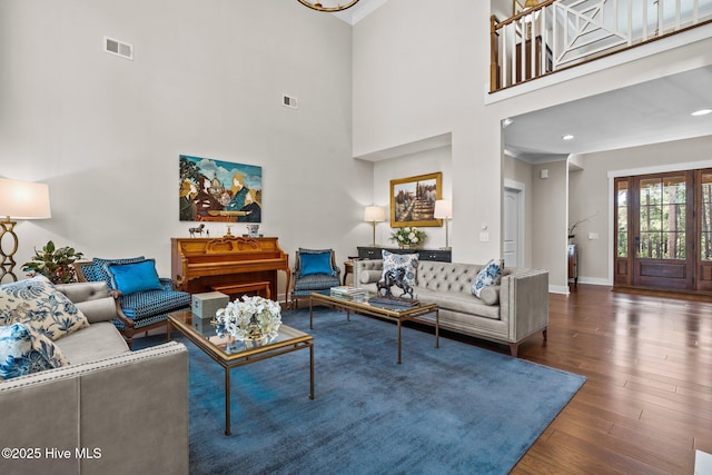 100 Holly Springs Ct, Southern Pines, NC 28387 - living area with wood finished floors, a towering ceiling, visible vents, crown molding, and baseboards