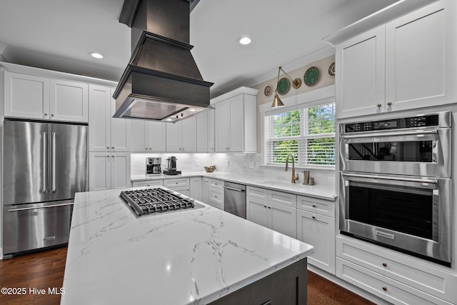 100 Holly Springs Ct, Southern Pines, NC 28387 - kitchen with a sink, appliances with stainless steel finishes, decorative backsplash, light stone counters, and custom range hood