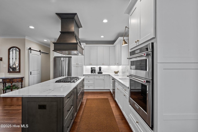100 Holly Springs Ct, Southern Pines, NC 28387 - kitchen featuring ornamental molding, white cabinetry, a kitchen island, custom range hood, and appliances with stainless steel finishes