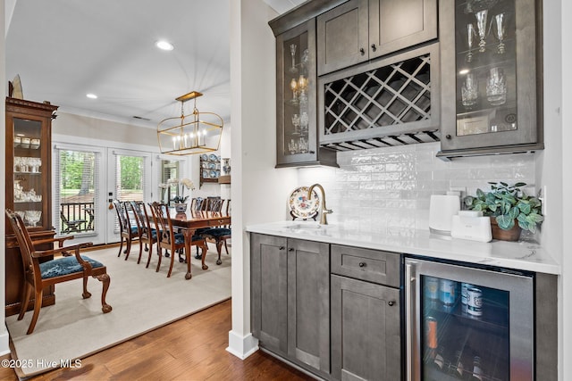 100 Holly Springs Ct, Southern Pines, NC 28387 - bar featuring beverage cooler, a sink, crown molding, indoor bar, and dark wood-style floors