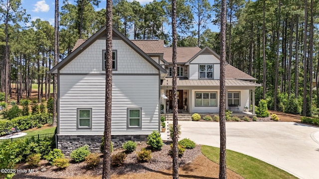 100 Holly Springs Ct, Southern Pines, NC 28387 - view of front of home featuring a porch, roof with shingles, and a standing seam roof