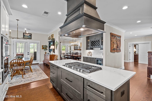 100 Holly Springs Ct, Southern Pines, NC 28387 - kitchen with crown molding, appliances with stainless steel finishes, island range hood, and a notable chandelier