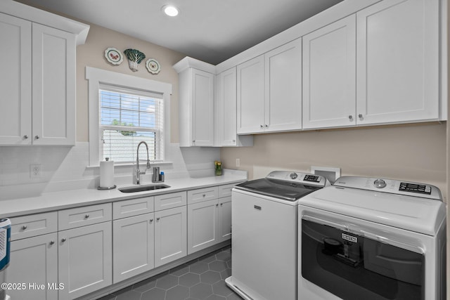 100 Holly Springs Ct, Southern Pines, NC 28387 - laundry room featuring a sink, washer and clothes dryer, cabinet space, dark tile patterned floors, and recessed lighting