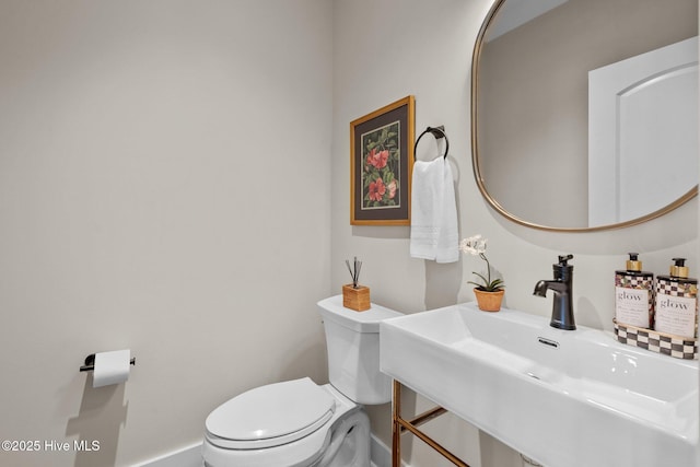 100 Holly Springs Ct, Southern Pines, NC 28387 - bathroom with toilet, baseboards, and a sink