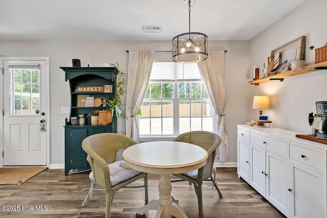 197 Cherry Rd, Southport, NC 28461 - dining room featuring wood finished floors, a chandelier, and baseboards
