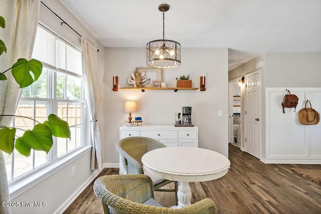 197 Cherry Rd, Southport, NC 28461 - dining area featuring dark wood-type flooring, plenty of natural light, a chandelier, and baseboards