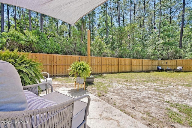 197 Cherry Rd, Southport, NC 28461 - view of patio / terrace with a fenced backyard and view of wooded area