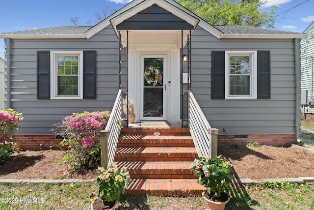 view of front of property with crawl space and a shingled roof