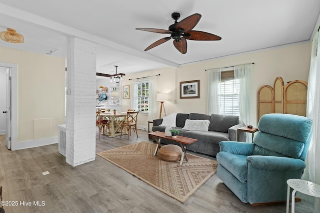 living area featuring ceiling fan, wood finished floors, and baseboards