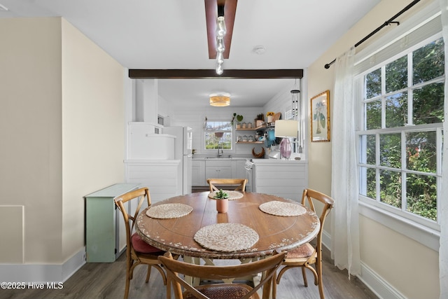 dining area with wood finished floors and baseboards