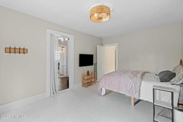 bedroom featuring finished concrete flooring