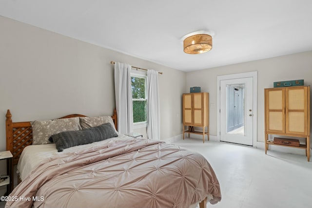 carpeted bedroom with baseboards and access to exterior