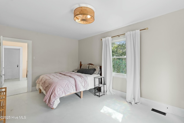 bedroom featuring visible vents and finished concrete flooring