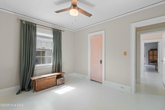 unfurnished room featuring ceiling fan, crown molding, and baseboards
