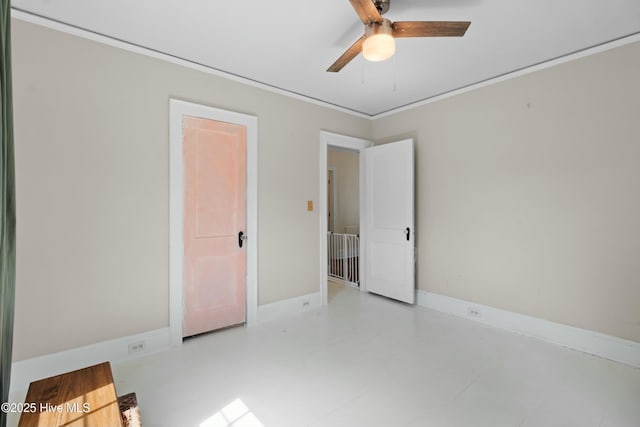 unfurnished bedroom featuring ornamental molding, ceiling fan, and baseboards