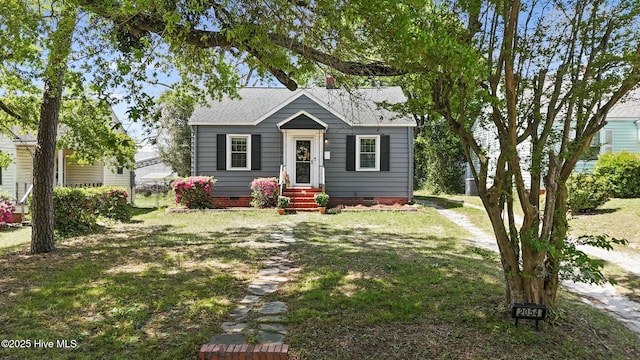 bungalow with roof with shingles, a front lawn, and crawl space