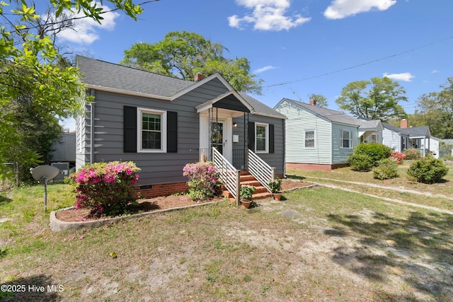 bungalow featuring a chimney, roof with shingles, a front lawn, and crawl space