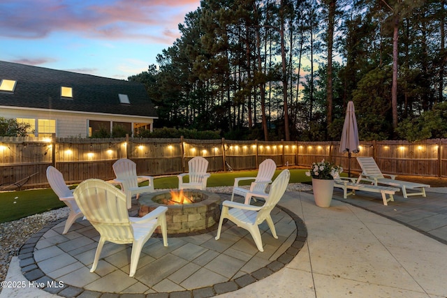 view of patio with a fire pit and a fenced backyard