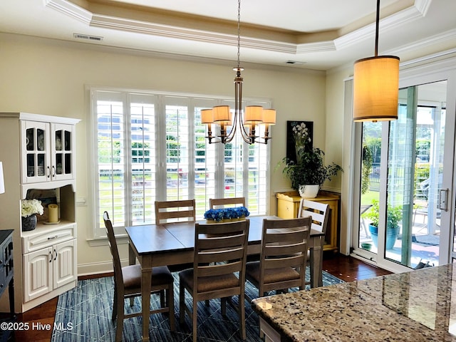 2208 Drawing Ct, Wilmington, NC 28412 - dining room with crown molding, a tray ceiling, a chandelier, and healthy amount of natural light