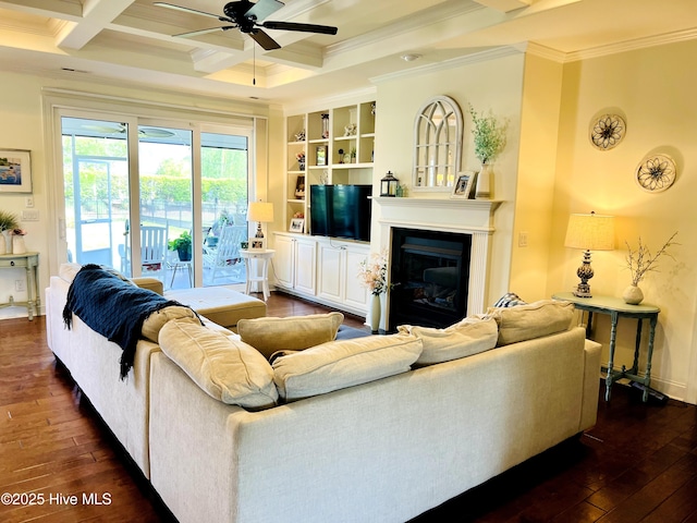 2208 Drawing Ct, Wilmington, NC 28412 - living room featuring a ceiling fan, crown molding, dark wood-style flooring, a glass covered fireplace, and beam ceiling