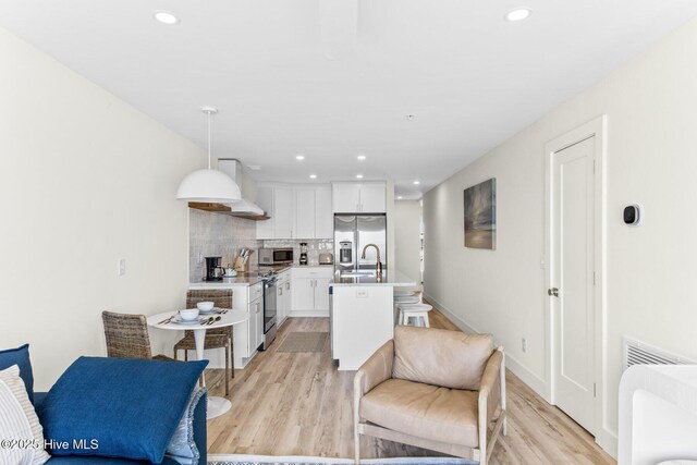 1800 Canal Dr Unit 102, Carolina Beach, NC 28428 - living area with light wood-type flooring, recessed lighting, and baseboards