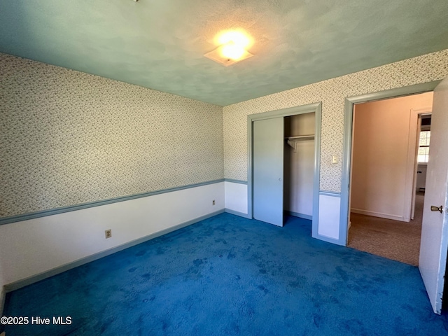 119 Emperor Landing Rd, Edenton, NC 27932 - unfurnished bedroom with baseboards, carpet floors, wallpapered walls, and a closet