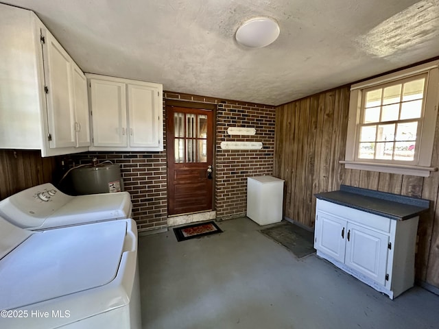 119 Emperor Landing Rd, Edenton, NC 27932 - laundry area featuring separate washer and dryer, brick wall, wood walls, water heater, and cabinet space