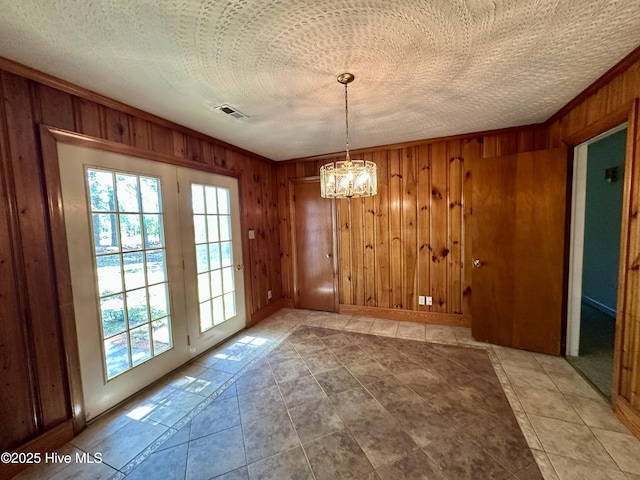 119 Emperor Landing Rd, Edenton, NC 27932 - unfurnished dining area with wooden walls, visible vents, tile patterned flooring, and a notable chandelier