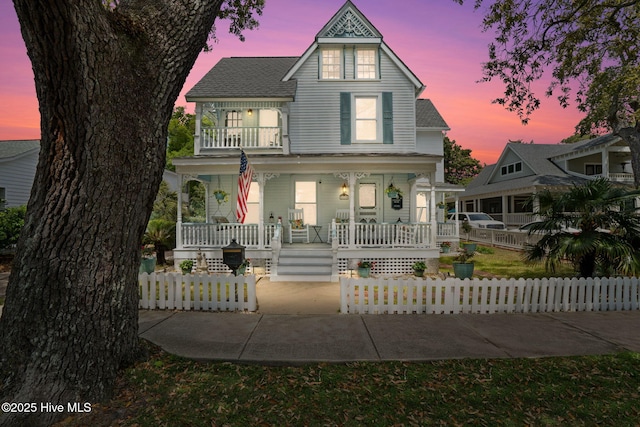 210 W W St, Southport, NC 28461 - view of front of property featuring a fenced front yard, roof with shingles, and covered porch