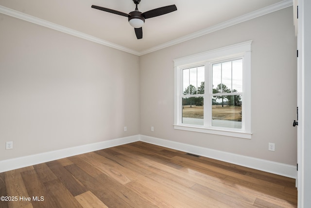 unfurnished room with baseboards, visible vents, wood finished floors, ceiling fan, and crown molding