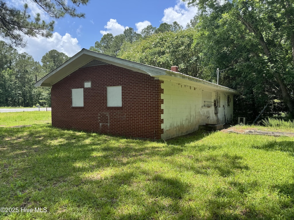 11085 Sam Potts Hwy, Lake Waccamaw, NC 28450 - view of property exterior with a lawn