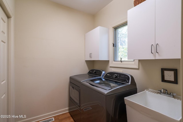 8 Driving Range Rd, Pinehurst, NC 28374 - laundry room featuring cabinet space, independent washer and dryer, wood finished floors, and baseboards