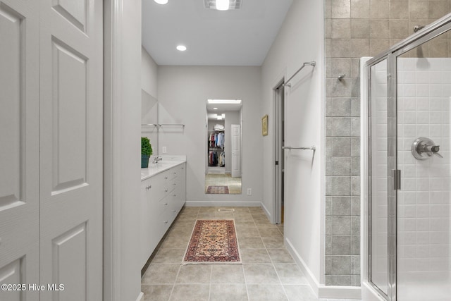 8 Driving Range Rd, Pinehurst, NC 28374 - full bathroom featuring a stall shower, tile patterned flooring, a walk in closet, vanity, and recessed lighting