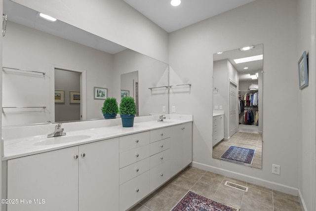 8 Driving Range Rd, Pinehurst, NC 28374 - full bathroom with double vanity, tile patterned floors, a walk in closet, baseboards, and recessed lighting