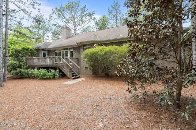 8 Driving Range Rd, Pinehurst, NC 28374 - back of property with a deck, a chimney, brick siding, roof with shingles, and stairs