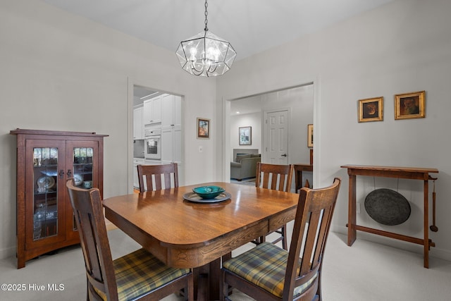 8 Driving Range Rd, Pinehurst, NC 28374 - dining room featuring a chandelier, light carpet, and baseboards
