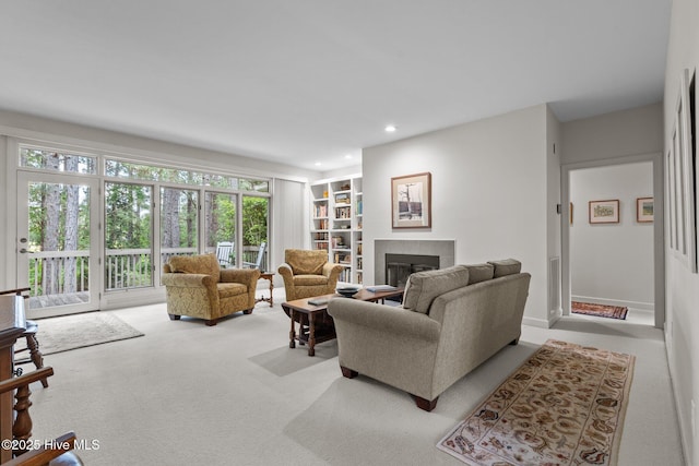 8 Driving Range Rd, Pinehurst, NC 28374 - carpeted living room with a tiled fireplace, recessed lighting, and built in shelves