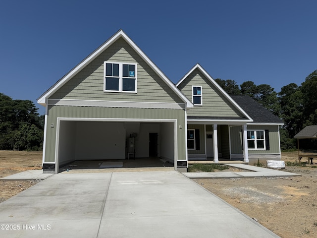 125 Tee Dr, Selma, NC 27576 - view of front of property with concrete driveway, covered porch, and an attached garage