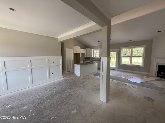 125 Tee Dr, Selma, NC 27576 - unfurnished living room featuring lofted ceiling and a fireplace with flush hearth