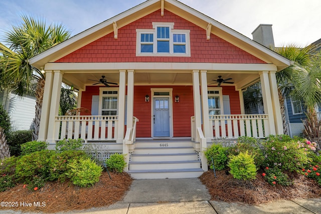 6445 Figure Eight Dr SW, Ocean Isle Beach, NC 28469 - view of front facade with ceiling fan, covered porch, and a chimney