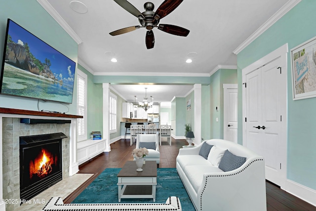 6445 Figure Eight Dr SW, Ocean Isle Beach, NC 28469 - living area with ornamental molding, a fireplace with flush hearth, a ceiling fan, baseboards, and recessed lighting