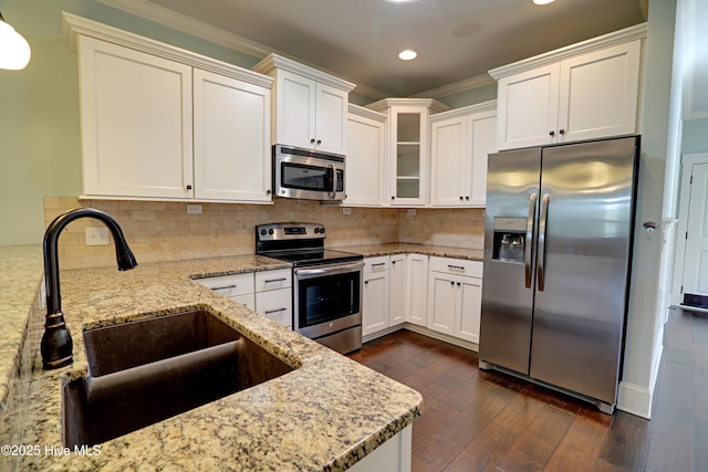 6445 Figure Eight Dr SW, Ocean Isle Beach, NC 28469 - kitchen with appliances with stainless steel finishes, a sink, recessed lighting, light stone countertops, and dark wood-type flooring