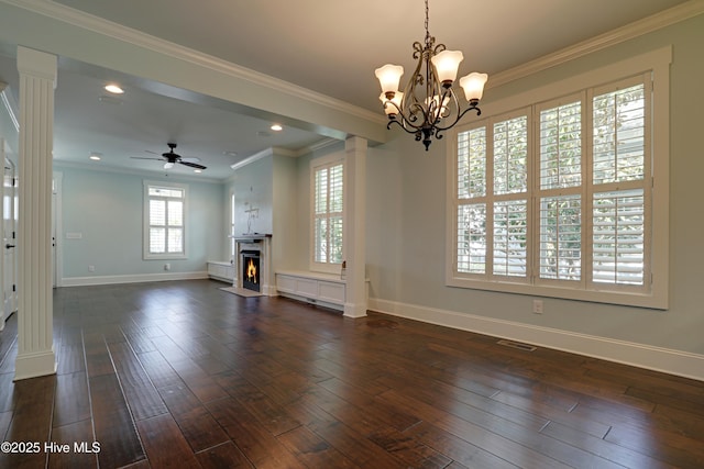 6445 Figure Eight Dr SW, Ocean Isle Beach, NC 28469 - unfurnished living room with baseboards, dark wood finished floors, a lit fireplace, ceiling fan, and ornamental molding