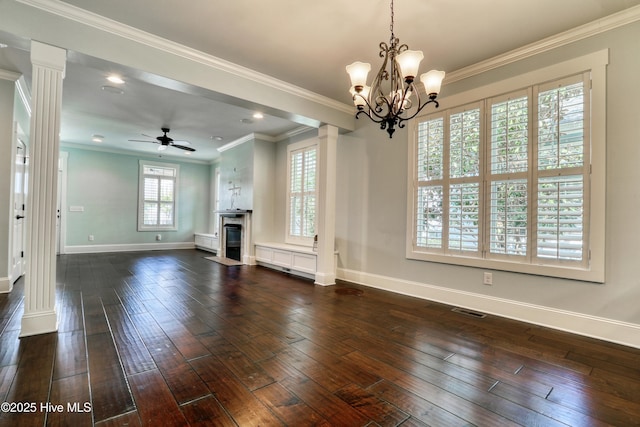 6445 Figure Eight Dr SW, Ocean Isle Beach, NC 28469 - unfurnished living room with ornate columns, dark wood-style flooring, baseboards, a fireplace with flush hearth, and a chandelier