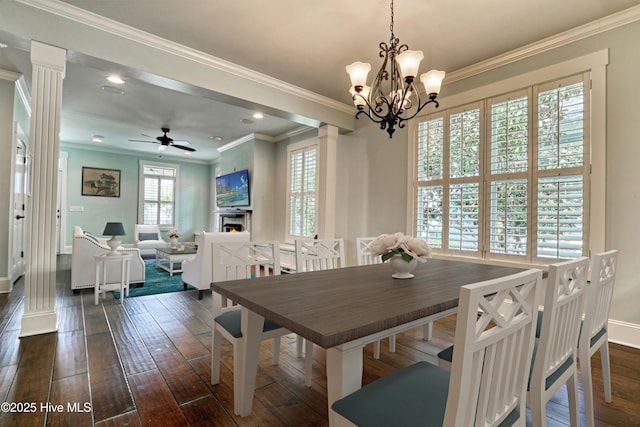 6445 Figure Eight Dr SW, Ocean Isle Beach, NC 28469 - dining area featuring dark wood-style floors, baseboards, a chandelier, ornate columns, and crown molding