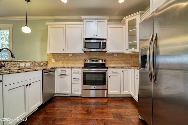 6445 Figure Eight Dr SW, Ocean Isle Beach, NC 28469 - kitchen featuring appliances with stainless steel finishes, a sink, ornamental molding, white cabinets, and dark wood-style floors