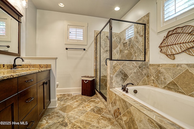 6445 Figure Eight Dr SW, Ocean Isle Beach, NC 28469 - bathroom featuring baseboards, a garden tub, vanity, a shower stall, and recessed lighting