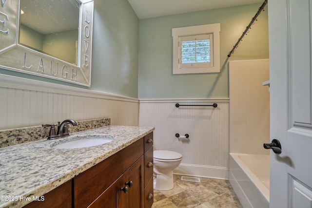 6445 Figure Eight Dr SW, Ocean Isle Beach, NC 28469 - full bath with vanity, a wainscoted wall, toilet, a bathtub, and a shower